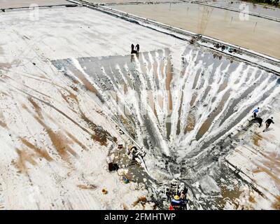 Lianyungang, China. 09th May, 2021. The workers are doing the salt tedding job in Lianyungang, Jiangsu, China on 09th May, 2021.(Photo by TPG/cnsphotos) Credit: TopPhoto/Alamy Live News Stock Photo