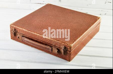 Vintage brown leather vinyl record box on white wooden background Stock Photo