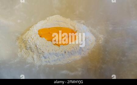 Flour and eggs on the marble floor Stock Photo