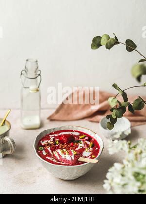 From above of tasty smoothie with fresh berries and ice candy with crushed pistachios and yogurt in bowl Stock Photo