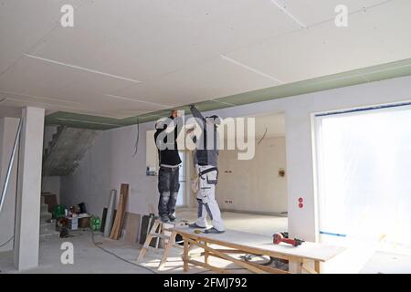 Men working on drywall construction Stock Photo