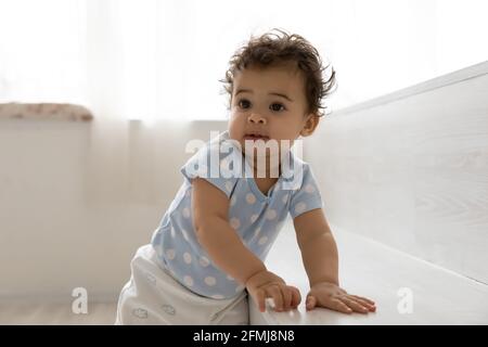 Cute little African American baby child play at home Stock Photo