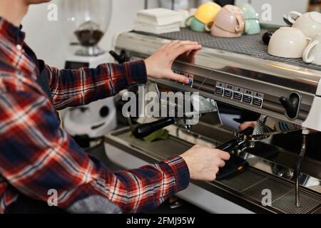 Barista using a coffee machine to make coffee Stock Photo