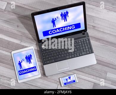 Coaching concept shown on different information technology devices Stock Photo