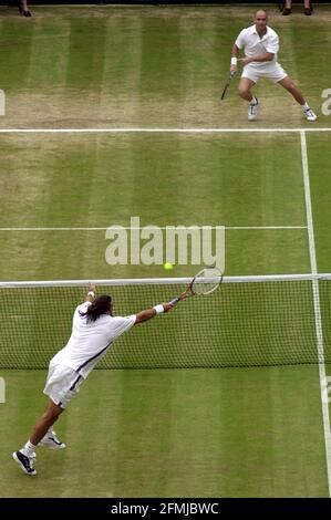 Patrick Rafter playing against Andre Agassi at Wimbledon July 2000 Patrick Rafter of Australia during the match against Andre Agassi of the US in their semi-final at the Wimbledon Tennis Championships.  Rafter won the match 7-5 4-6 7-5 4-6 6-3 to go through to the final Stock Photo