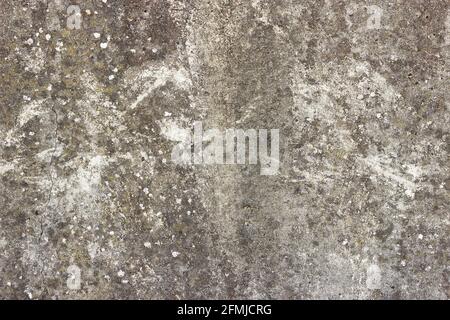 A flat grey concrete surface with a few spots of white lichen Stock Photo