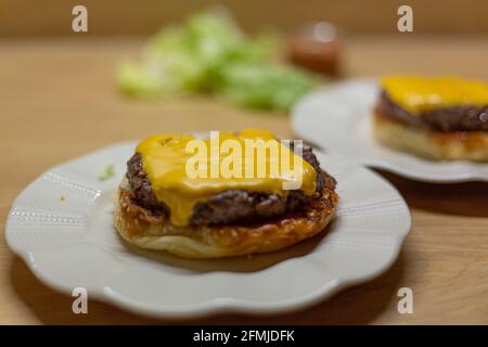 Burger bread with sesame is heating on a grill pan. Process of cooking self  made burgers at home Stock Photo - Alamy