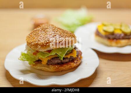 Burger bread with sesame is heating on a grill pan. Process of cooking self  made burgers at home Stock Photo - Alamy