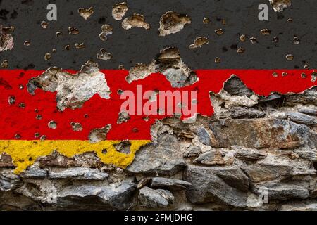Concept of the Political Situation in Germany with a damaged painted flag on a cracked wall with wholes. 3D-Illustration. 3D-rendering Stock Photo