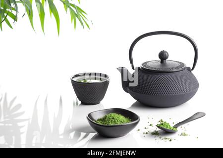 Matcha tea powder and tea accessories on white base. Tea ceremony. Traditional japanese drink Stock Photo