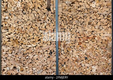 Stacked firewood with parts of boards and wooden strips Stock Photo