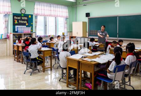 The teacher at BoAi school in Shanxi, China explains the lesson to her students. Stock Photo
