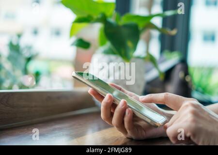 Woman hand using smartphone to do work business, social network, communication concept. Stock Photo