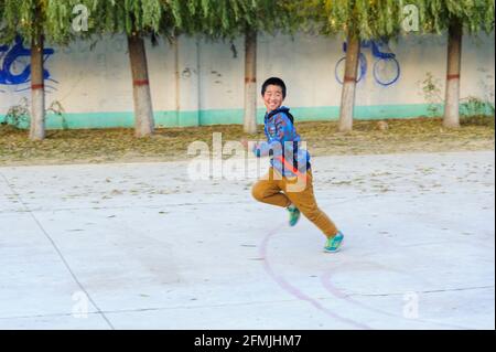 Students from Lixian school in rural Hebei, China runs away during the Capture the Flag game. Stock Photo