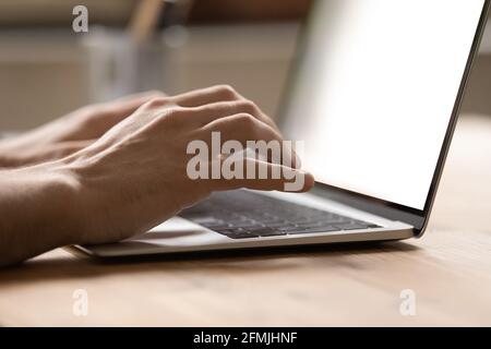 Close up businessman using laptop, typing on keyboard, writing message Stock Photo