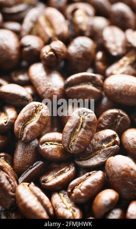 Close up picture of dark freshly roasted coffee beans, selective focus. Stock Photo