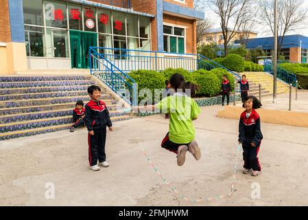 Student jump rope during their recess time at BoAi school in Shanxi, China Stock Photo