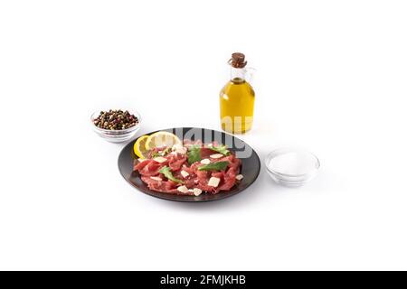 Marbled beef carpaccio on black plate isolated on white background Stock Photo