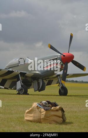 P 51 mustang world war two fighter aircraft, parked with a kit bag in the foreground. Stock Photo