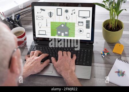 Home automation concept shown on a laptop used by a man Stock Photo