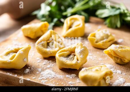 Uncooked pelmeni dumplings on wooden table Stock Photo