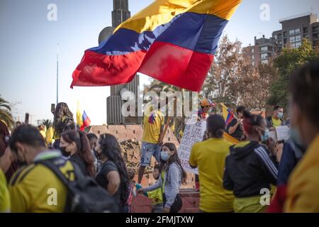 A protester waves a flag during the demonstration. Colombian residents in chile protest in solidarity with their country and against Ivan Duque's government, political abuse and repression, since 28 April tax reform was announced to mitigate the country's economic crisis. The protests in Colombia leave at least 47 dead and more than 900 reportedly injured. Stock Photo
