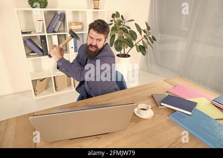 Software license agreement. Slow internet connection. Outdated software. Computer lag. Lagging system. Hate office routine. Man bearded crush computer Stock Photo