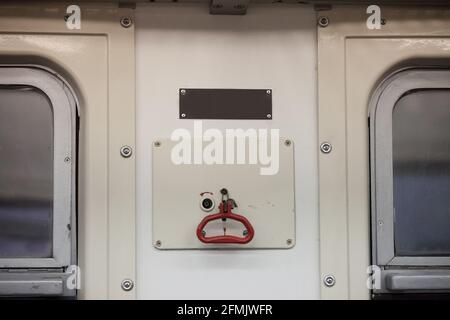 Picture of a railway emergency brake trigger system taken in a passenger train, that is being used only in case of emergency. Stock Photo