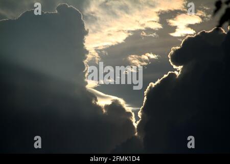 Dark large clouds covering the sun Stock Photo