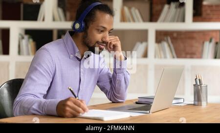 Close up African American man in headphones watching webinar, studying Stock Photo