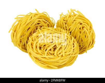Chinese dried medium egg noodle nests isolated on a white background Stock Photo