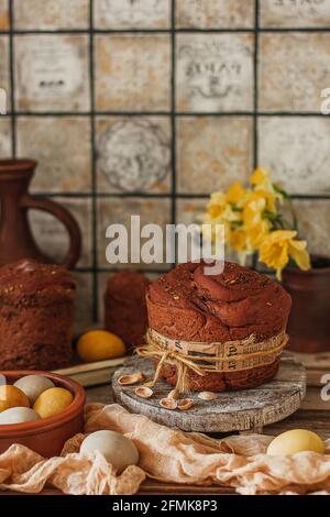 Kulich cake with yellow daffodil flowers, and painted eggs symbol of Traditional Russian Orthodox Easter Stock Photo