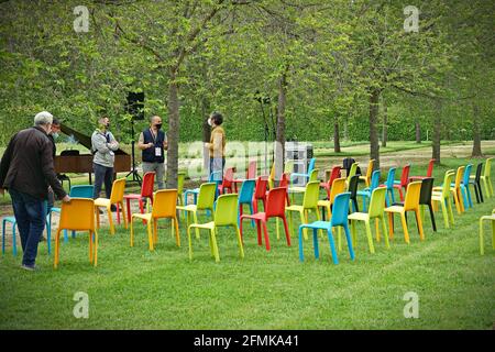 Row of multicolored empty chairs for an outdoor event.  Milan, Italy - May 2021 Stock Photo