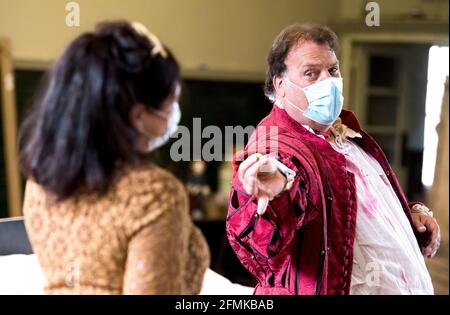 Sara Fulgoni and Bryn Terfel are masked and socially distanced during a rehearsal of Falstaff for the Grange Park Opera. The rehearsals have been taking part at Alford House, in London, before the opera is seen from the 10th June-18 July. Picture date: Monday May 10, 2021. Stock Photo