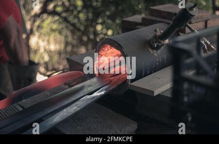 Heating steel in a gas forge Stock Photo