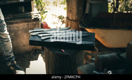 Metal knives on an anvil Stock Photo