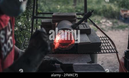 Heating steel in a gas forge Stock Photo