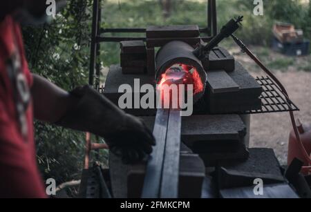 Heating steel in a gas forge Stock Photo