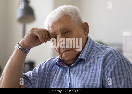 Upset elderly male feel desperate tired having mental health problems Stock Photo