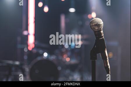 Close up of a microphone on a concert stage with beautiful lighting. Stock Photo