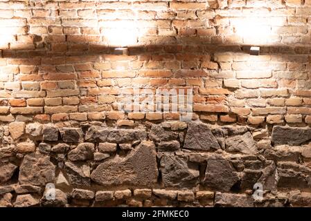 Masonry of generations of stone and brick. In the basement, the old part of the building was excavated from rough stones before the appearance of bric Stock Photo