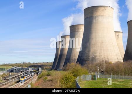 Ratcliffe-on-Soar coal power station with steam from cooling towers and a train at Parkway station Ratcliffe on soar Nottinghamshire England Stock Photo