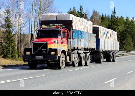 Classic conventional Volvo N12 VTA 8X2 truck pulling loaded full trailer on highway 2 on a day of spring. Forssa, Finland. April 29, 2021. Stock Photo