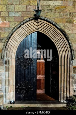 Door to the 12th. Century St. Aidan’s Curch, Bamburgh, Northumberland. Stock Photo