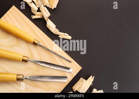 Set of gauges on wooden plank on black background. Woodworking or carpentry flat lay. Top view. Copy space Stock Photo