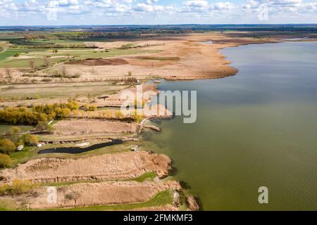 A bird's eye view of the lake shore, thickets on the lake - a photo from a drone. Stock Photo