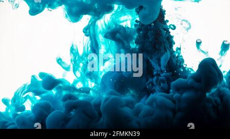 Ink in water. Abstract background. Ink swirling in water. Ink in water isolated on white background. Blue ink in water. Stock Photo