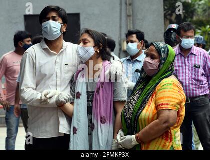 New Delhi, India. 10th May, 2021. Wailing family members console each other after they performed the last rites of their loved ones who died from COVID-19 at Nigombodh ghat crematorium in New Delhi, India, May 10, 2021. Credit: Partha Sarkar/Xinhua/Alamy Live News Stock Photo