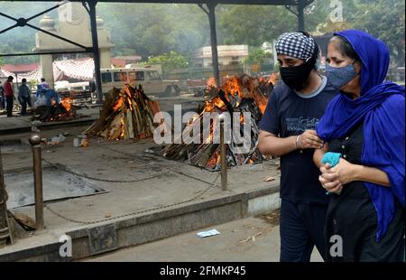 New Delhi, India. 10th May, 2021. Wailing family members console each other after they performed the last rites of their loved ones who died from COVID-19 at Nigombodh ghat crematorium in New Delhi, India, May 10, 2021. Credit: Partha Sarkar/Xinhua/Alamy Live News Stock Photo