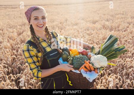 Farmer woman offering healthy vegetables Stock Photo